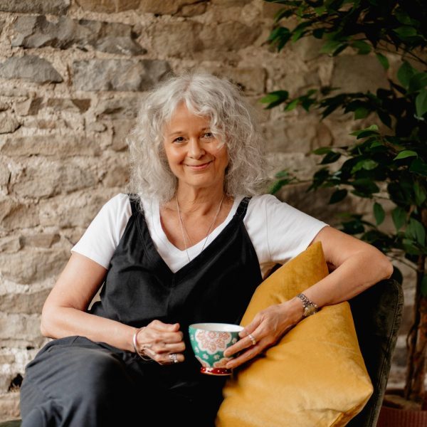 photo of Helen Maggie Watson sat with a cup of tea