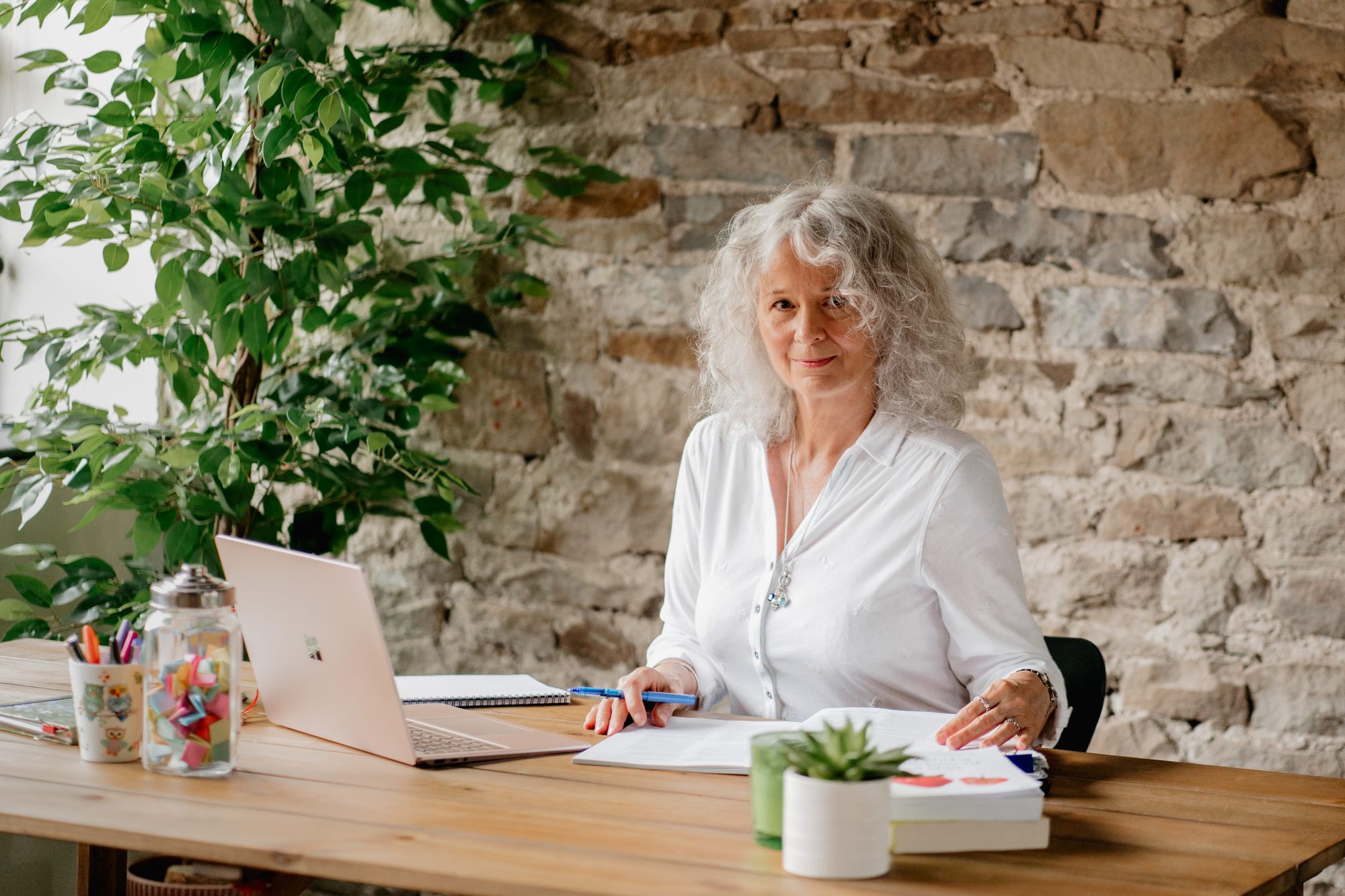 photo of Helen Maggie Watson at her desk analysing evidence based services