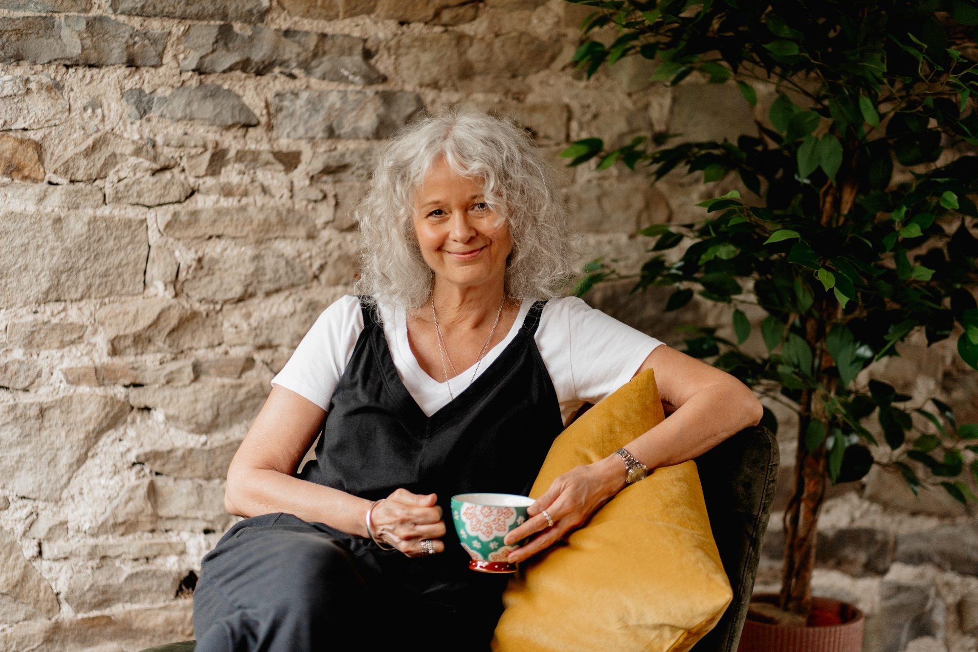 photo of Helen Maggie Watson sat with a cup of tea